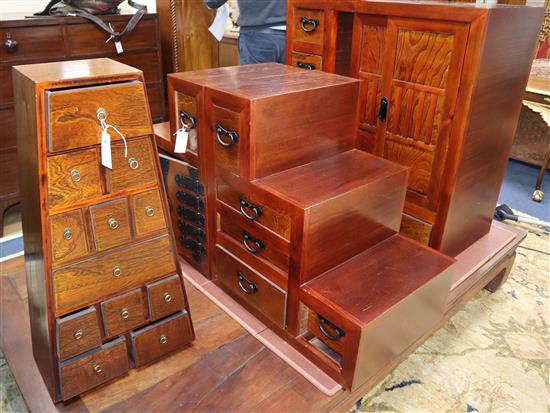 A Japanese elm cabinet, an elm cabinet of drawers of tapered form and two stepped cabinets Largest 84cm wide